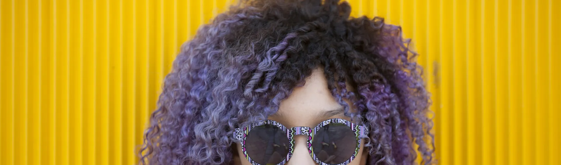 a close up image of a lady wearing sunglasses