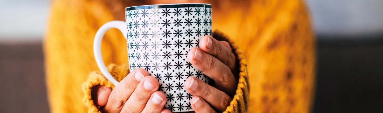 Lady holding a branded coffee mug from Ignition Marketing 