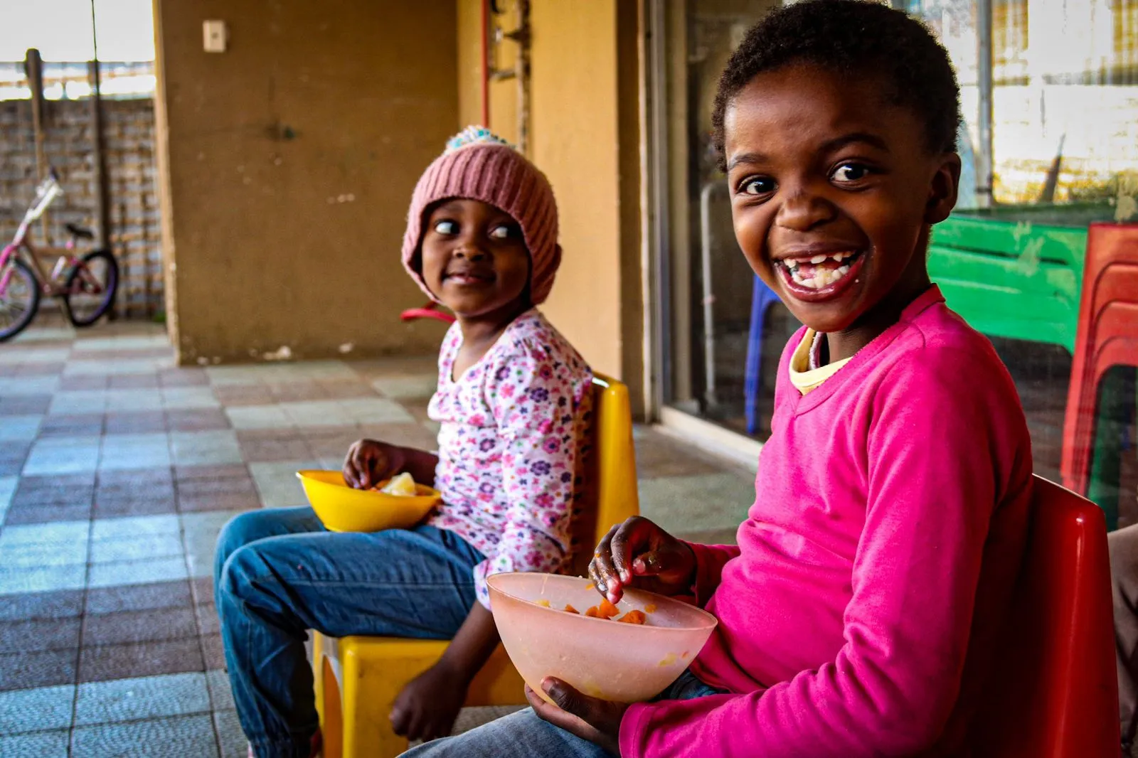 2 young children sitting togther eating food, Ignition cares &amp; ladies love