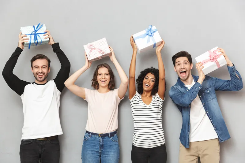 a group holding up their Year end thank you gift boxes
