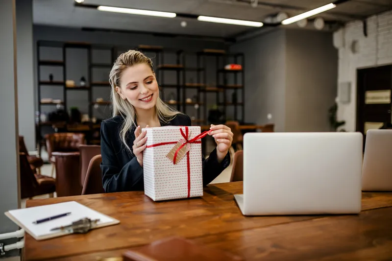 A lady unwrapping a gift box